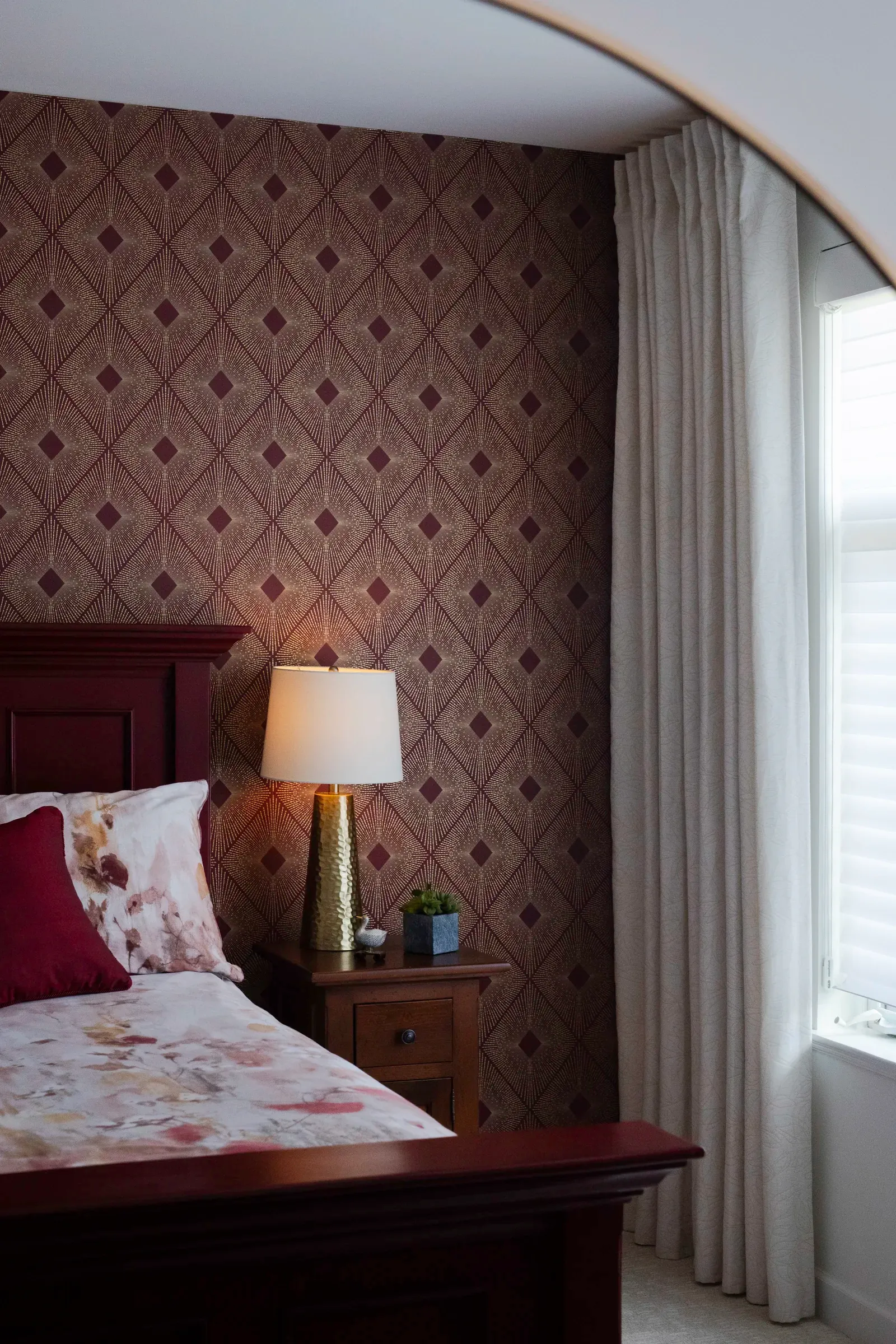 Bedroom with custom drapery and patterned wallcovering