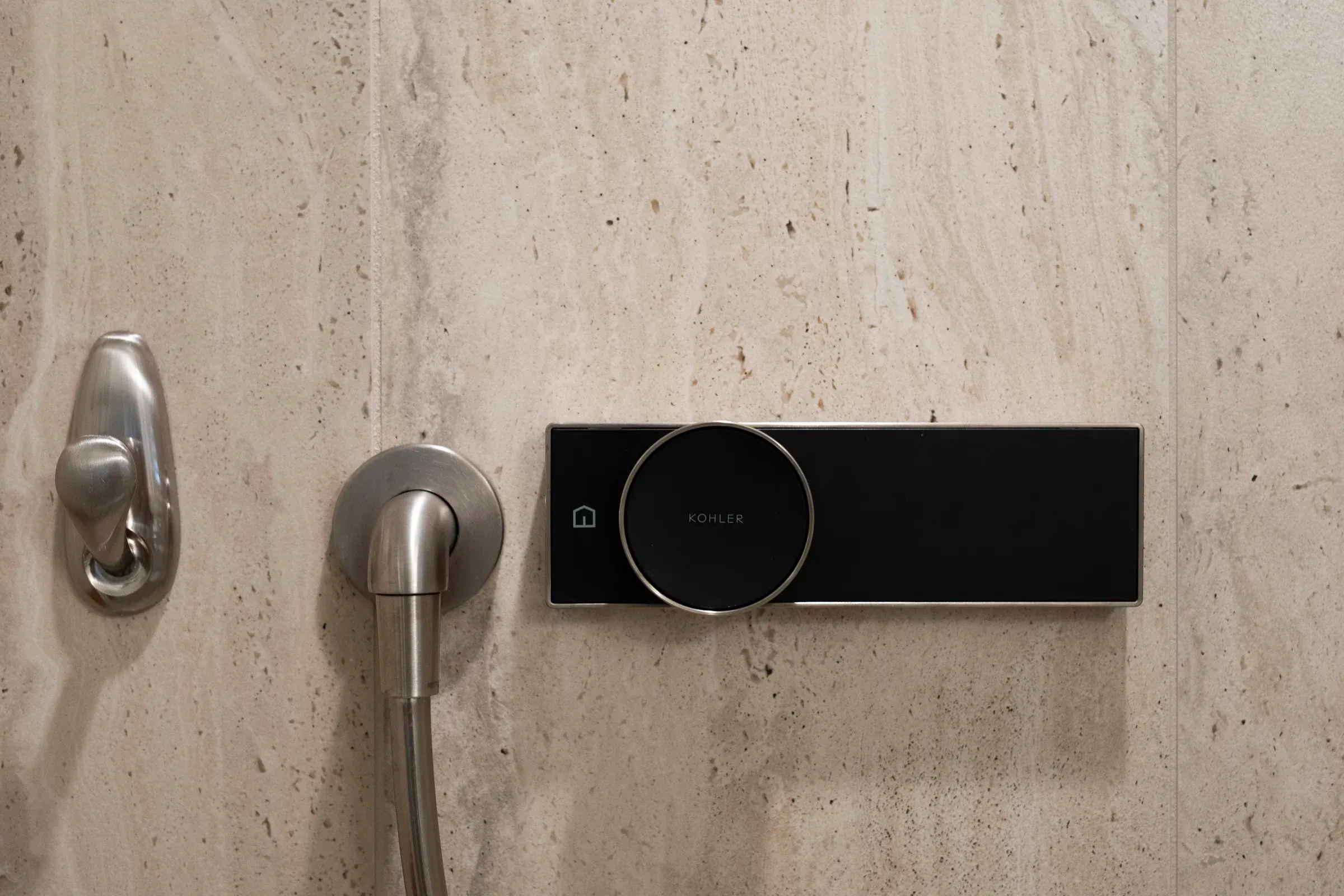 Integrated shower controls set into stone tile
