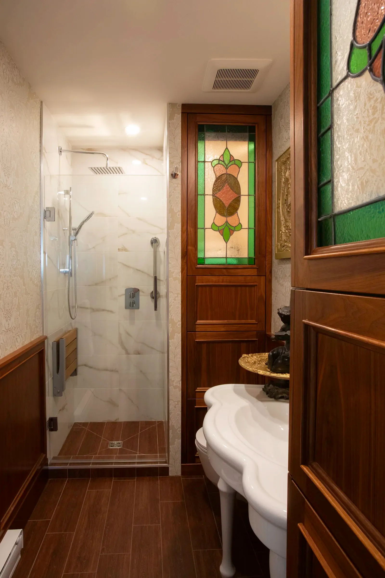 Renovated shower with stained glass and custom millwork
