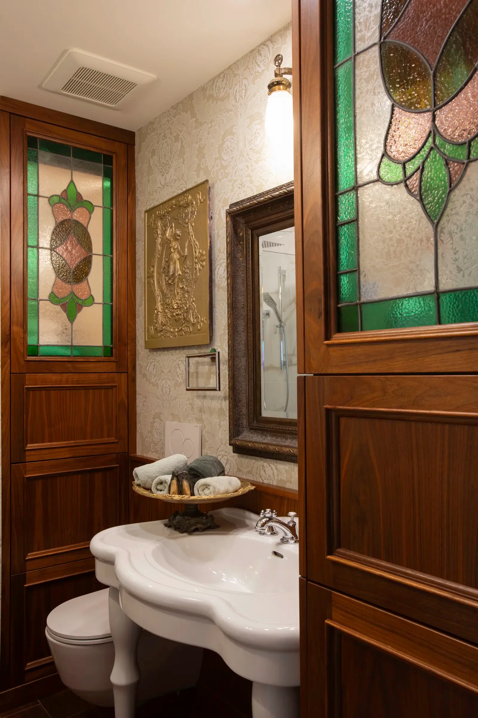 Detailed bathroom with rich wood panelling and stained glass